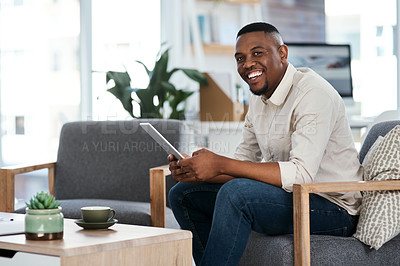 Buy stock photo Portrait of a young businessman using a digital tablet in an office