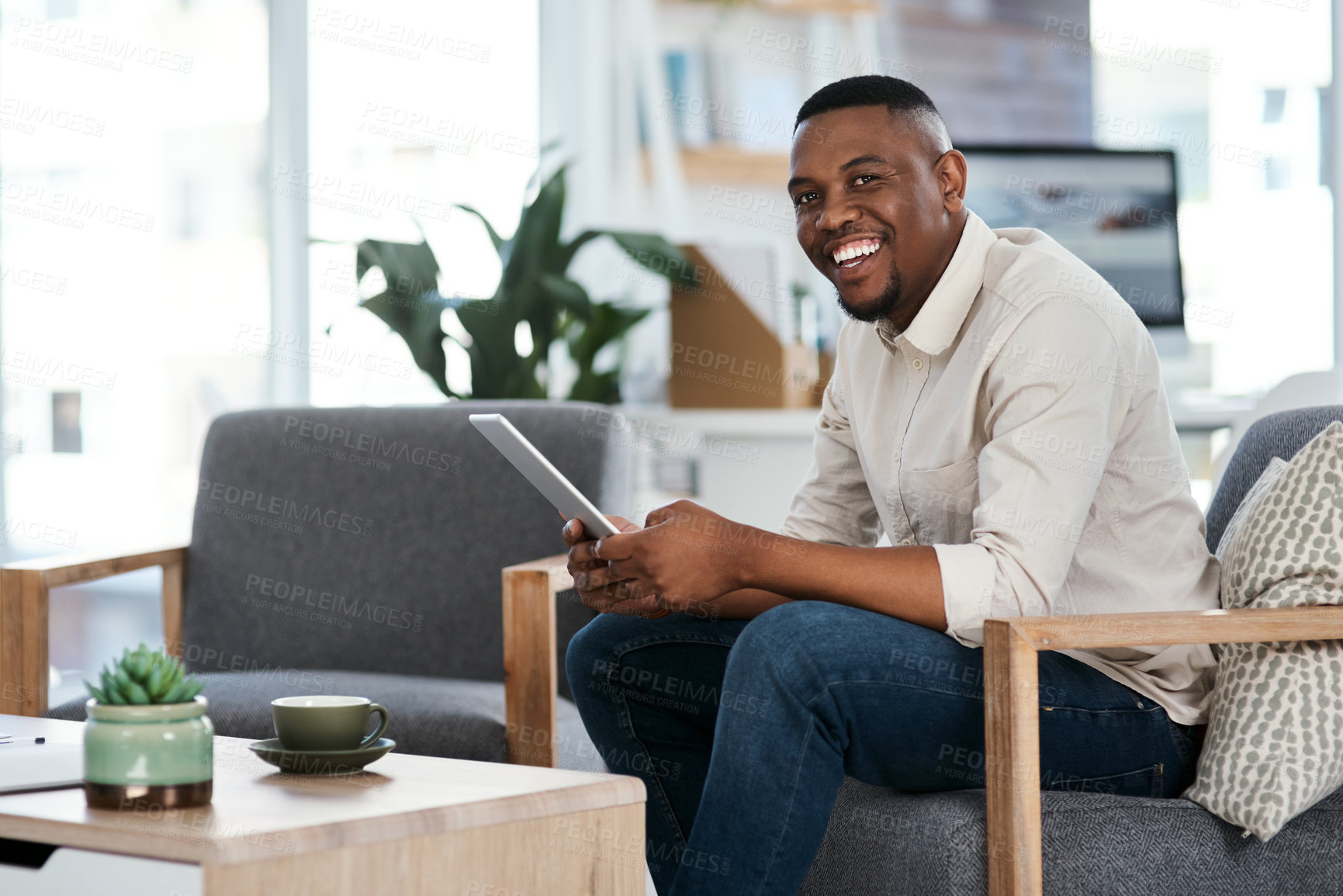 Buy stock photo Portrait of a young businessman using a digital tablet in an office