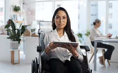 Buy stock photo Cropped portrait of an attractive young businesswoman in a wheelchair using her tablet in the office