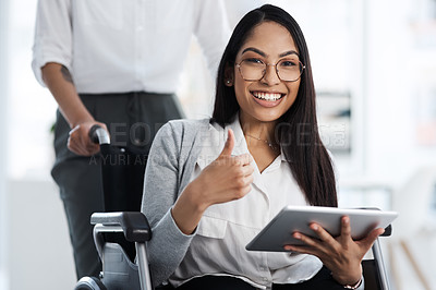 Buy stock photo Cropped portrait of an attractive young businesswoman in a wheelchair using her tablet and giving thumbs up in the office