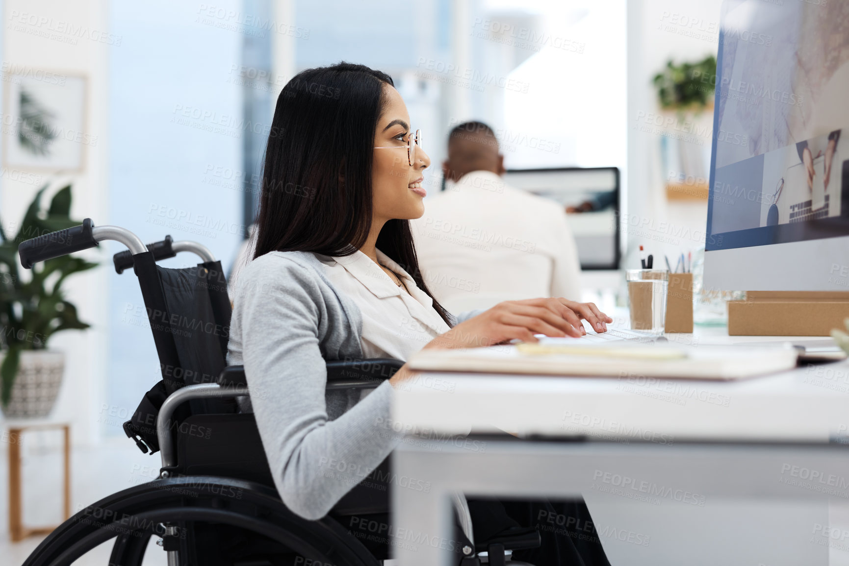 Buy stock photo Cropped shot of an attractive young businesswoman working on a computer at her desk in the office