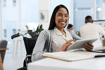 Buy stock photo Cropped portrait of an attractive young businesswoman working on a tablet at her desk in the office