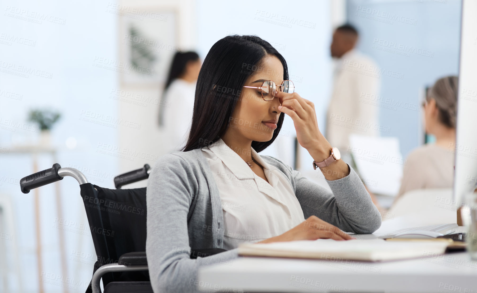 Buy stock photo Cropped shot of an attractive young businesswoman looking stressed while working at her desk in the office