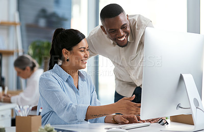 Buy stock photo Shot of two businesspeople working together on a computer in an office