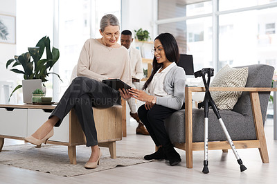 Buy stock photo Full length shot of an attractive young businesswoman getting some information from her human resources manager in the office