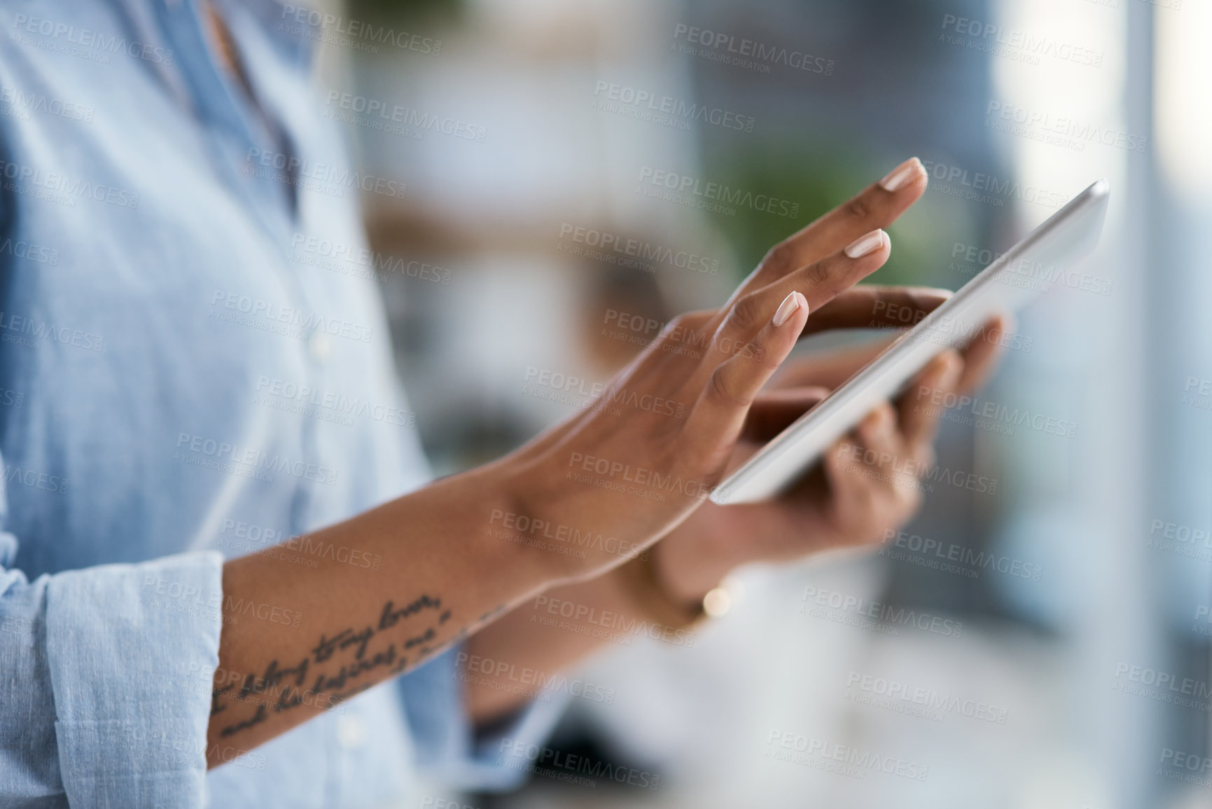 Buy stock photo Closeup shot of an unrecognisable businesswoman using a digital tablet in an office