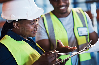 Buy stock photo Shot of two young contractors standing in the warehouse and having a discussion while doing a stock-take