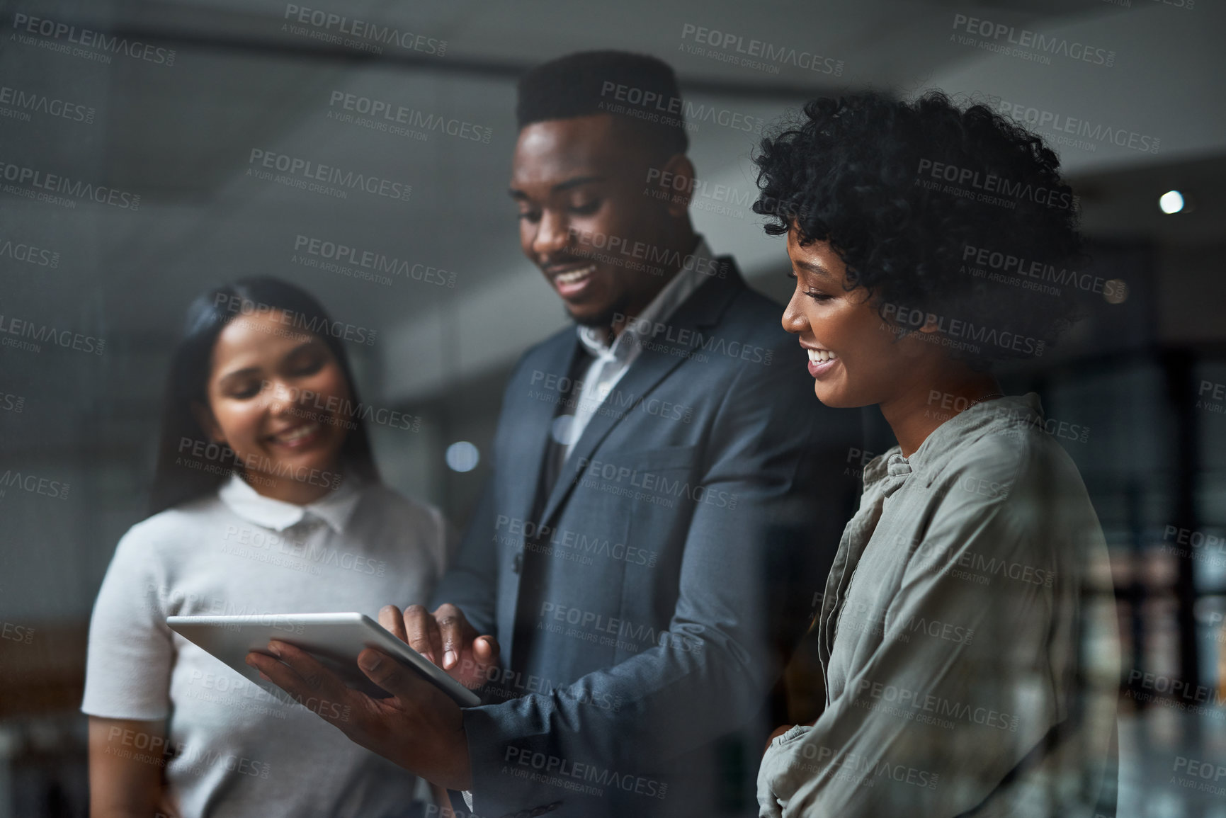 Buy stock photo Shot of three businesspeople working in a modern office