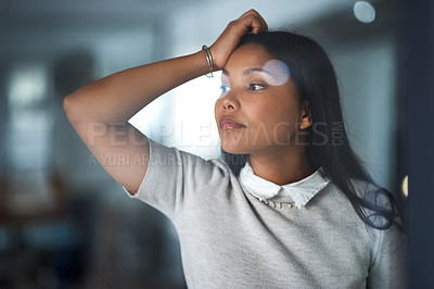 Buy stock photo Shot of a young businesswoman looking out the window in an office