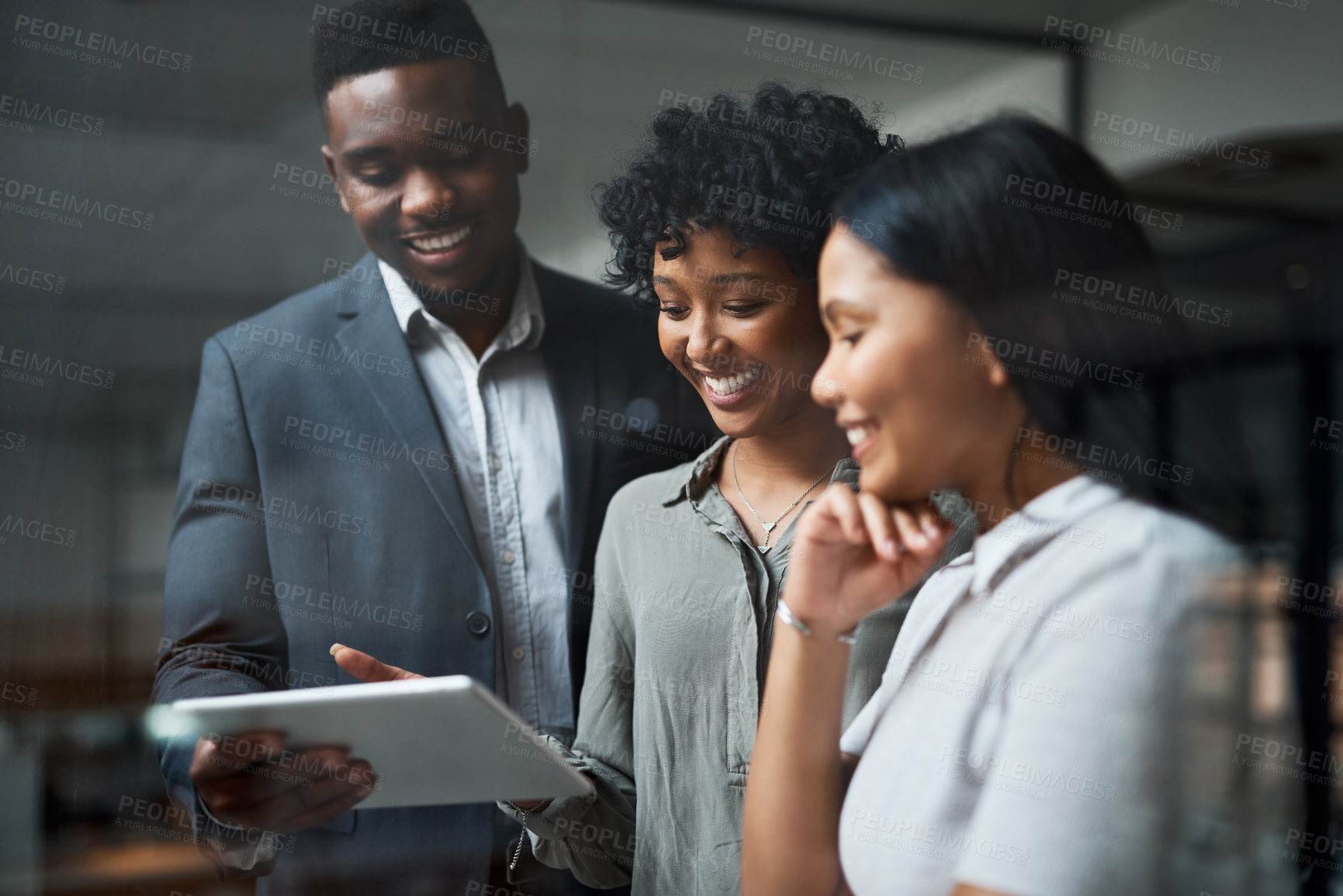 Buy stock photo Shot of three businesspeople working in a modern office