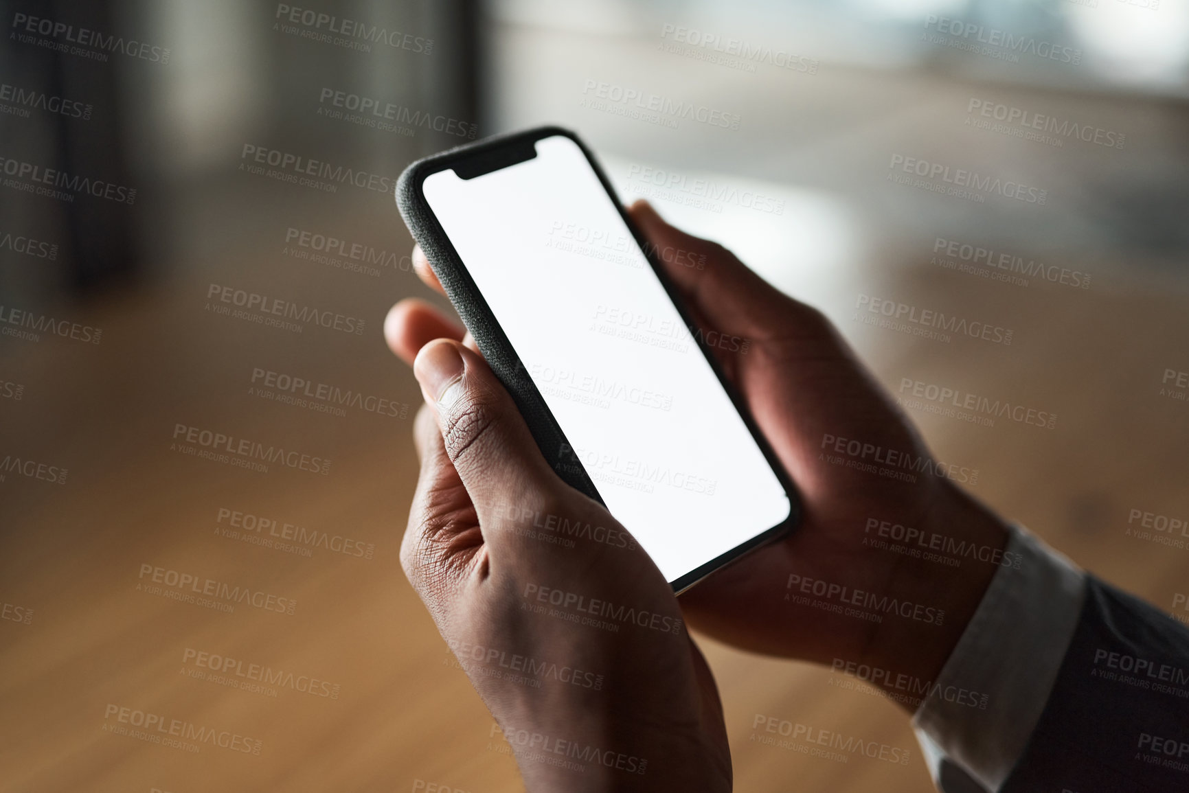 Buy stock photo Cropped shot of an unrecognizable person using their phone in the office