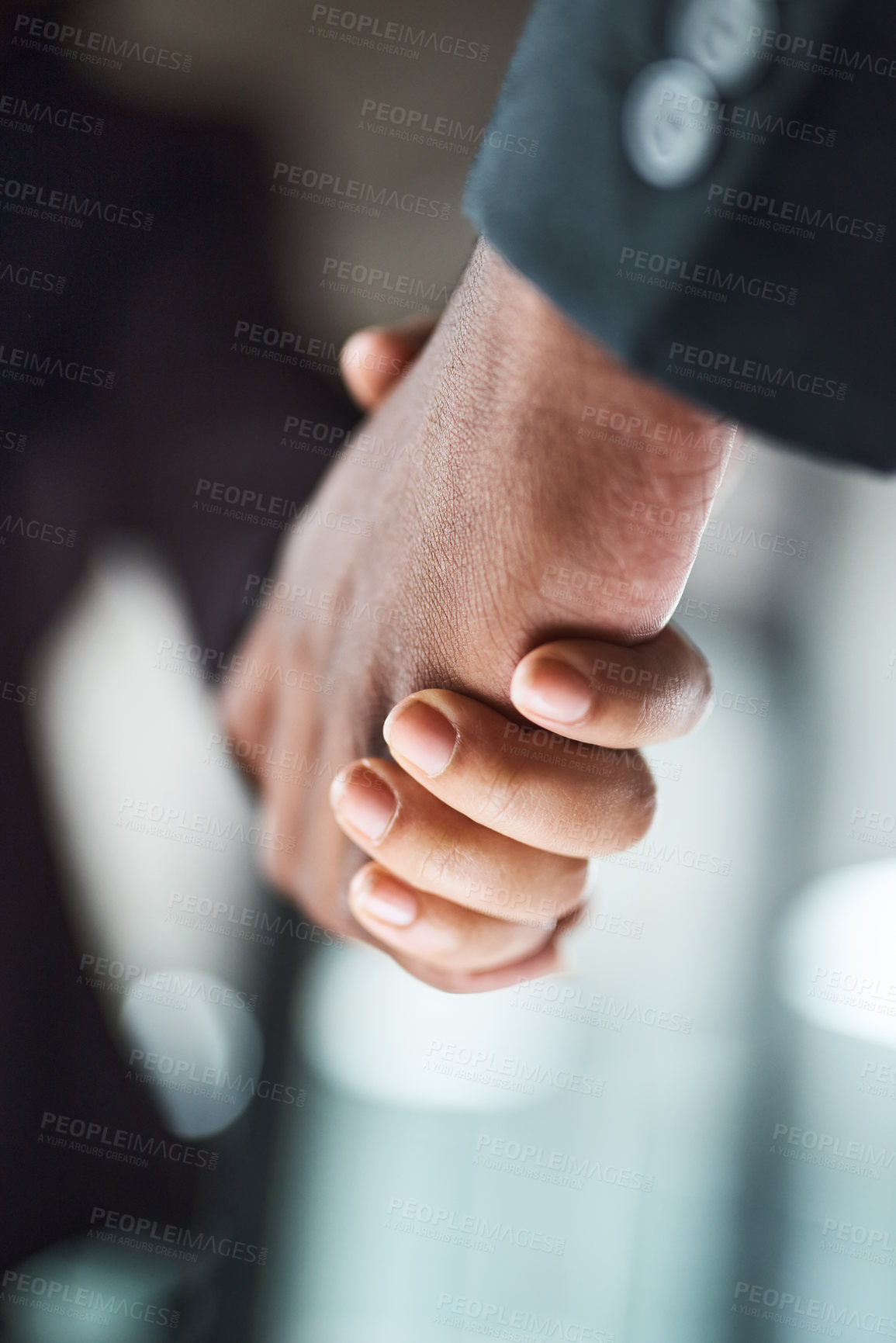 Buy stock photo Cropped shot of two unrecognizable businesspeople shaking hands in an office