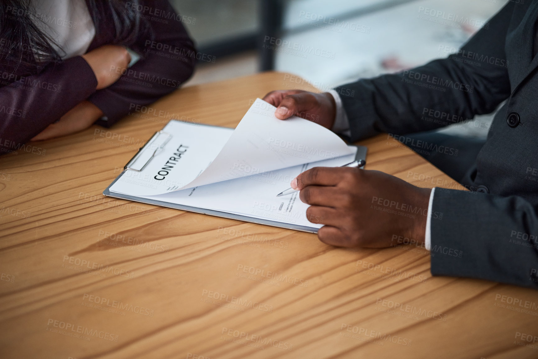 Buy stock photo Cropped shot of two businesspeople filling in paperwork in an office