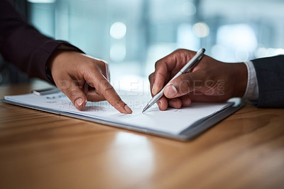 Buy stock photo Cropped shot of two businesspeople filling in paperwork in an office