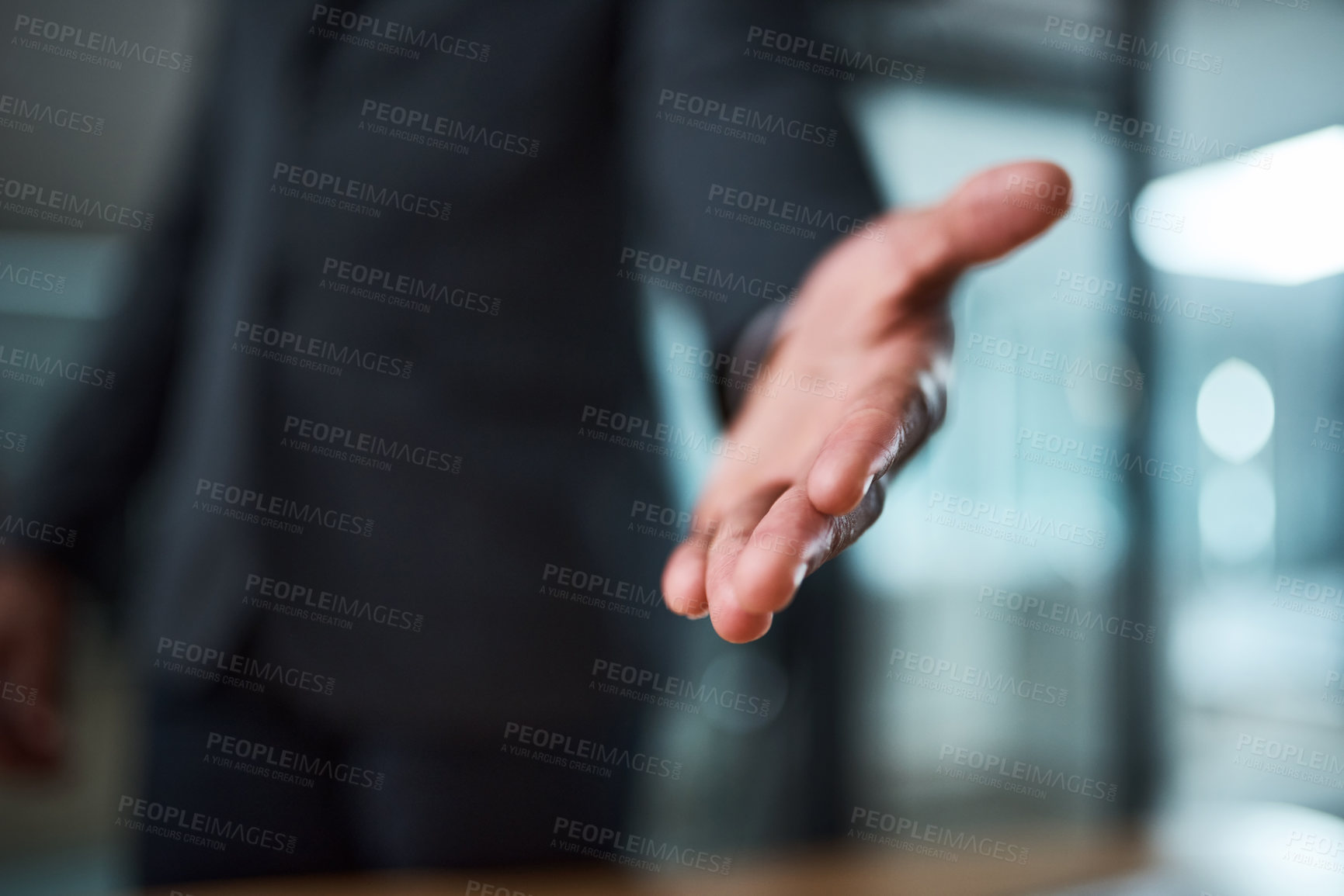 Buy stock photo Cropped shot of an unrecognizable businessman extending a handshake in an office