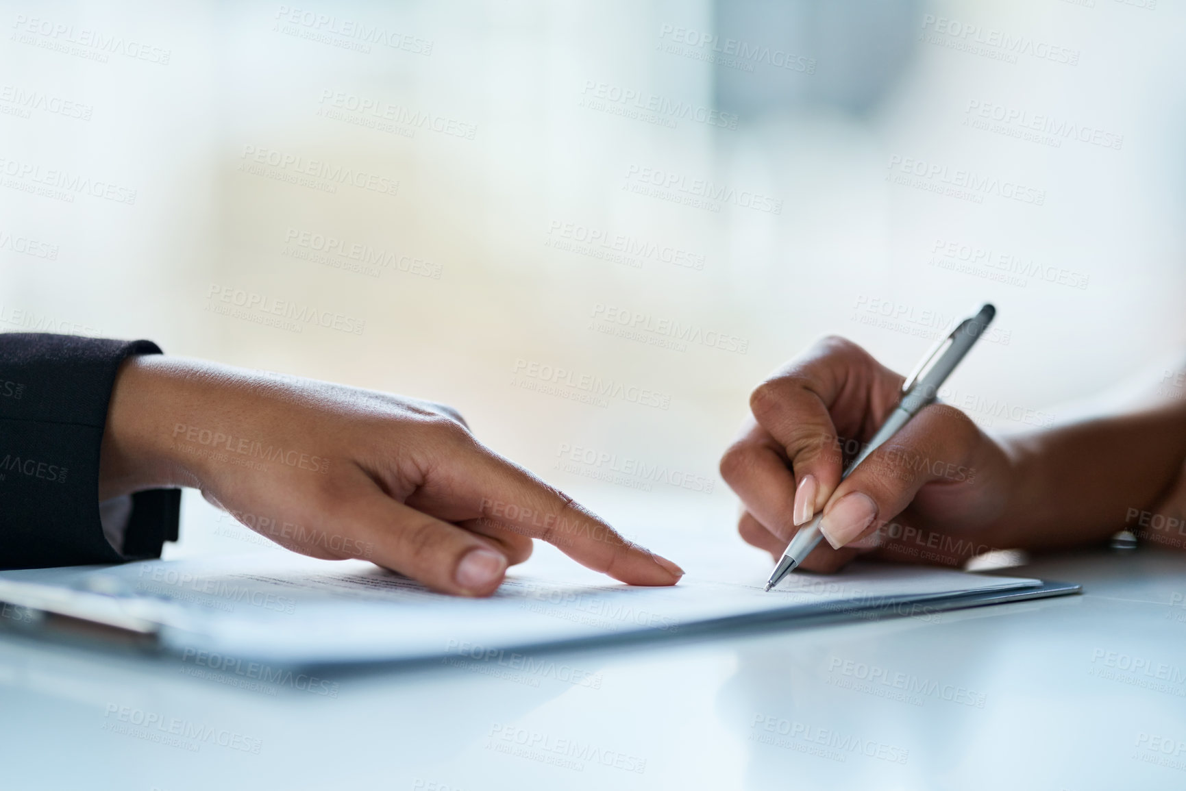 Buy stock photo Closeup shot of two businesspeople filling in paperwork in an office