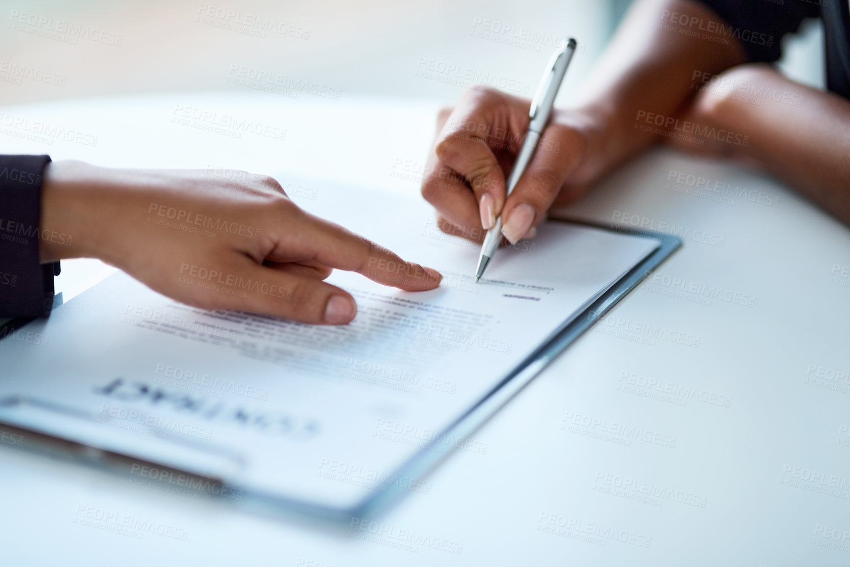 Buy stock photo Closeup shot of two businesspeople filling in paperwork in an office