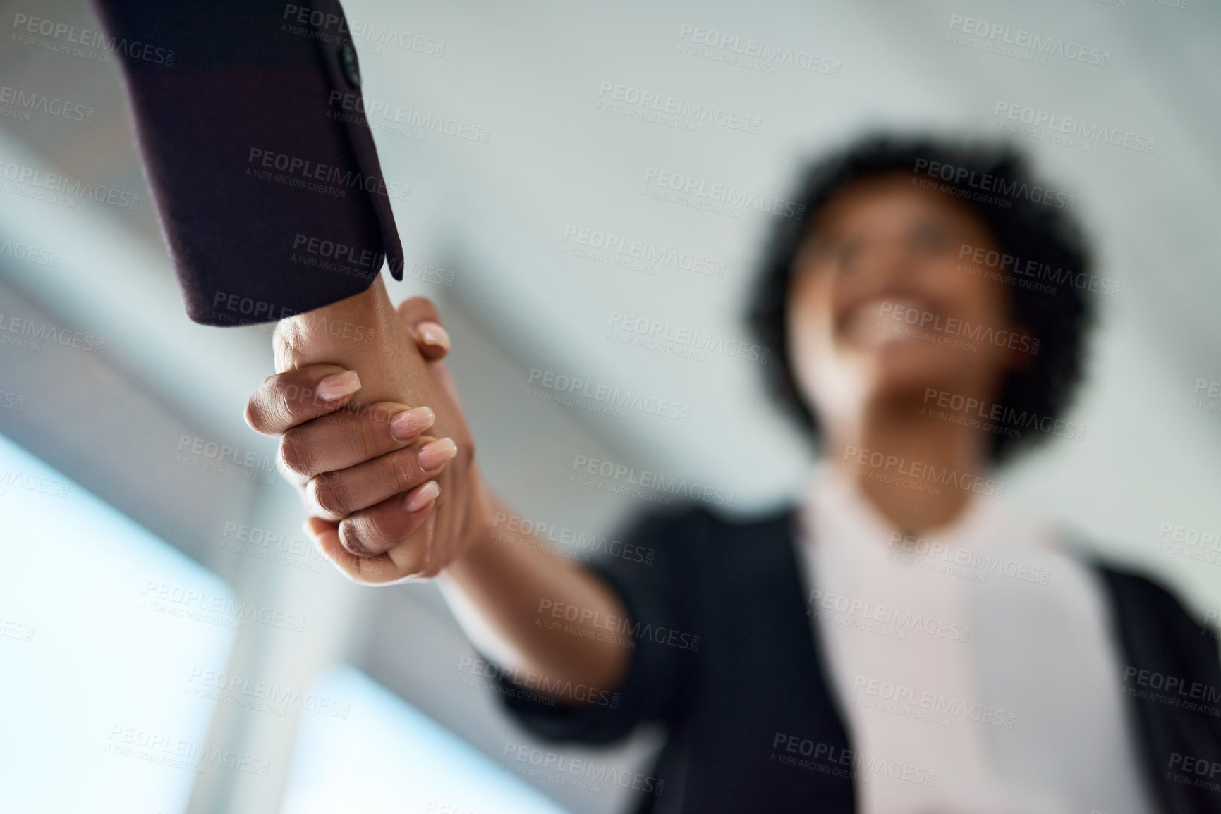 Buy stock photo Cropped shot of two unrecognizable businesspeople shaking hands in an office