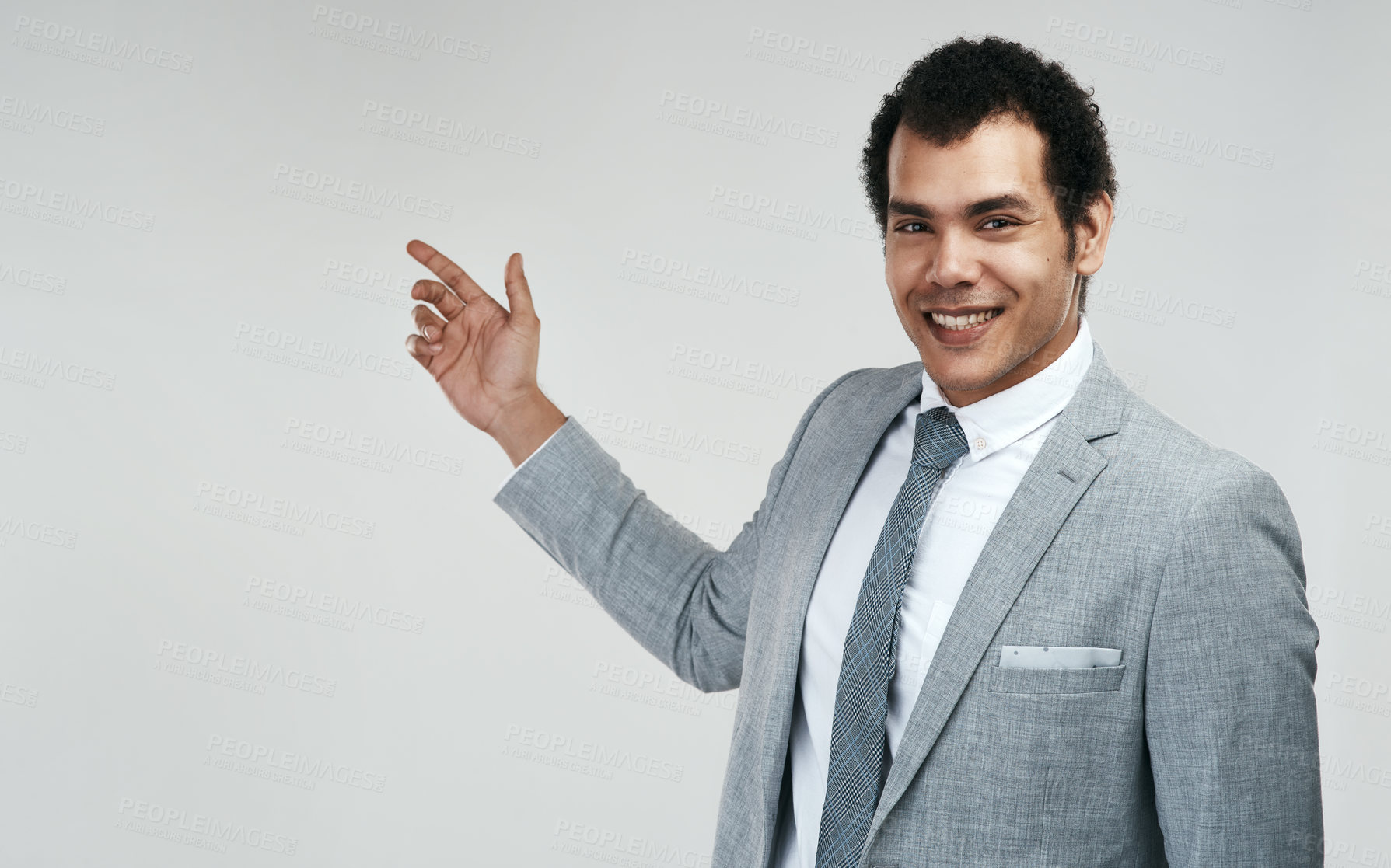 Buy stock photo Studio shot of a businessman pointing at copyspace against a grey background