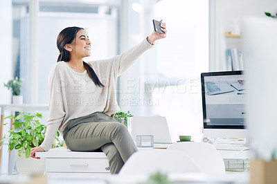 Buy stock photo Shot of a young businesswoman taking selfies in an office