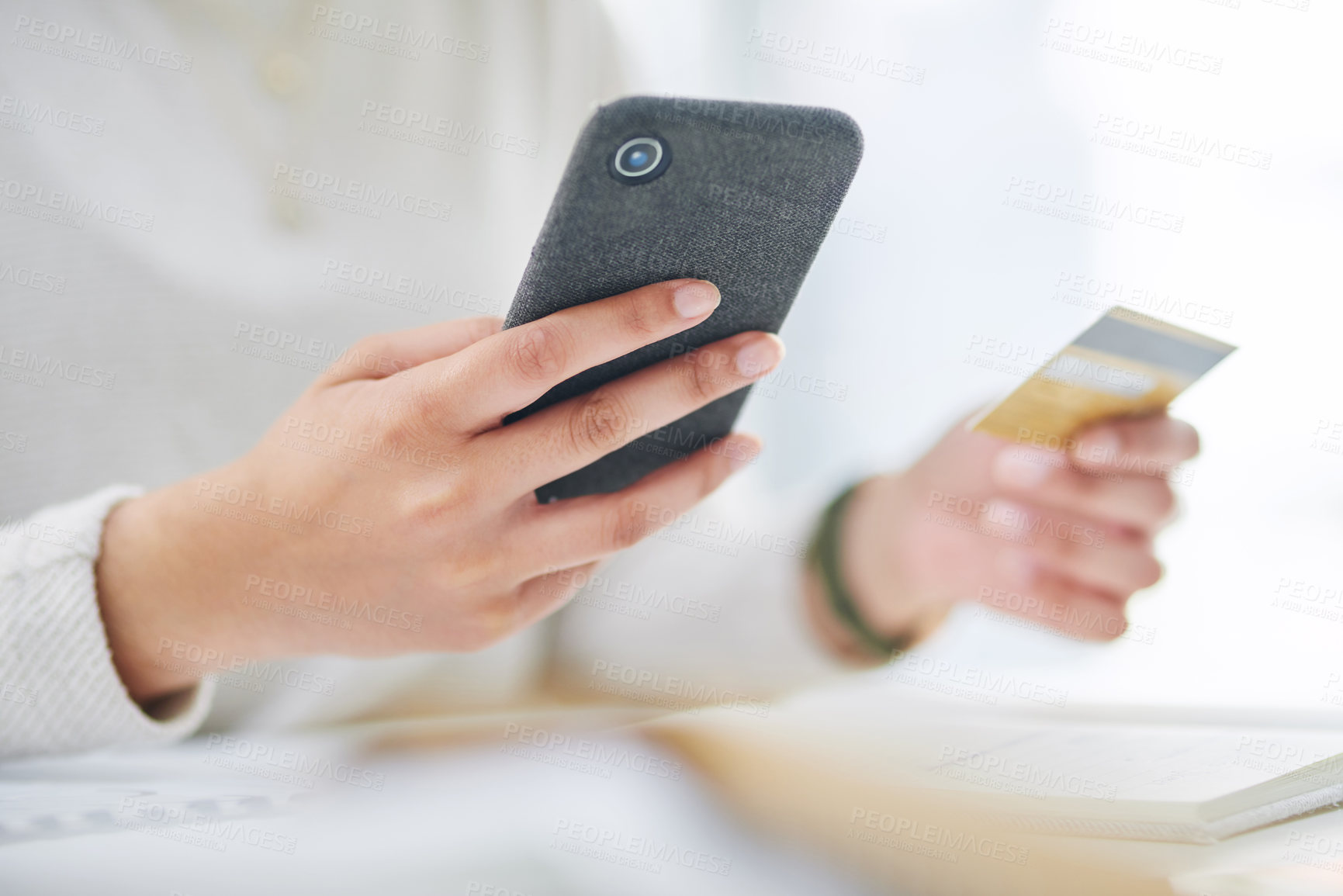 Buy stock photo Closeup shot of an unrecognisable businesswoman using a cellphone and credit card in an office