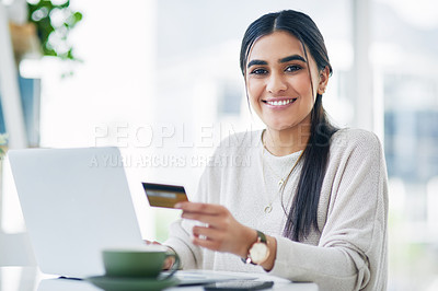 Buy stock photo Portrait of a young businesswoman using a laptop and credit card in an office