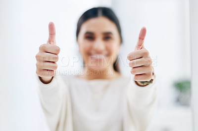 Buy stock photo Closeup shot of a young businesswoman showing thumbs up in an office