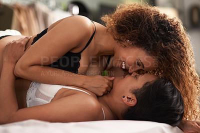 Buy stock photo Shot of a young couple being intimate in their bedroom