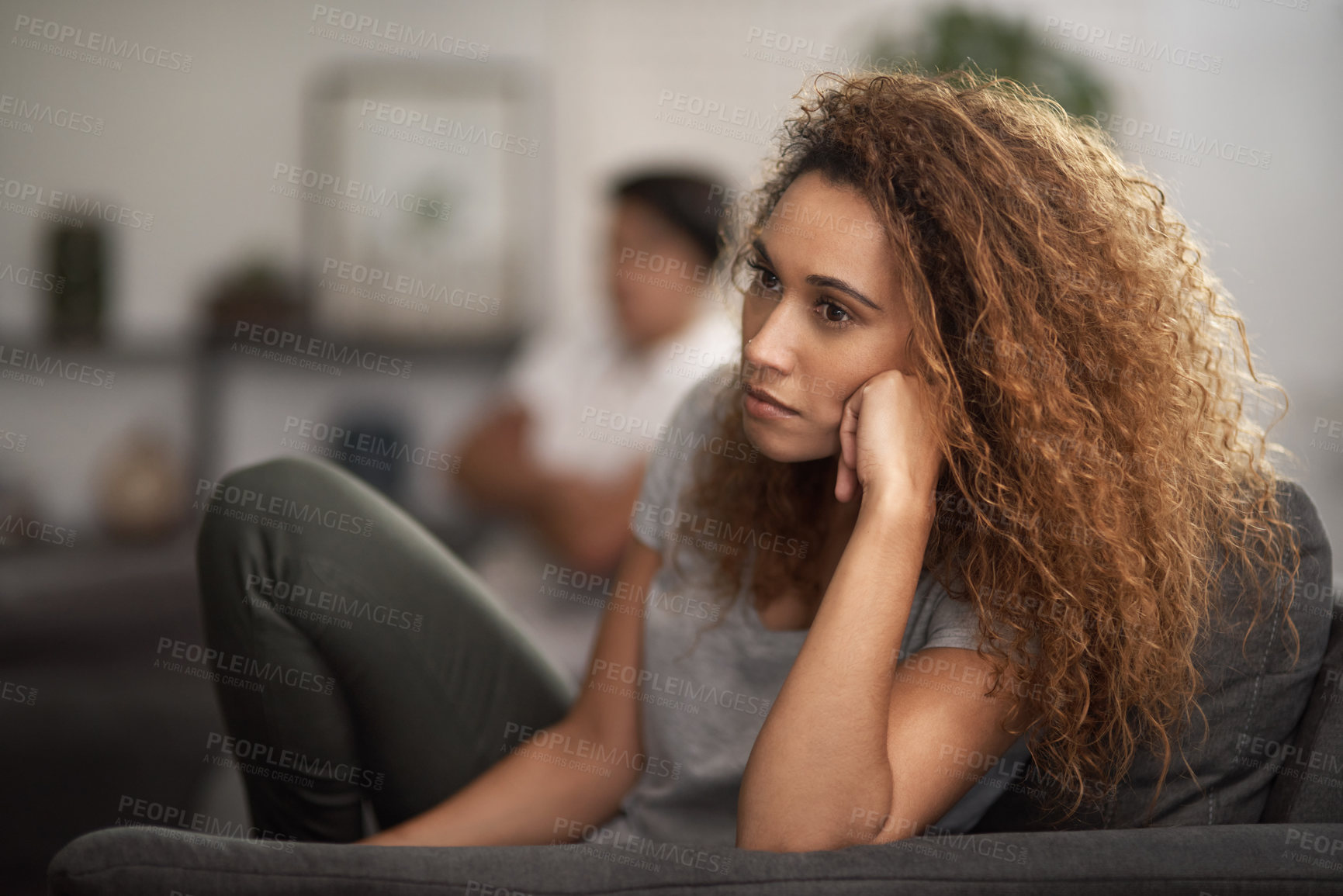 Buy stock photo Shot of a young woman ignoring her partner at home