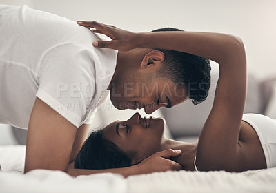 Buy stock photo Shot of a young couple sharing an intimate moment at home