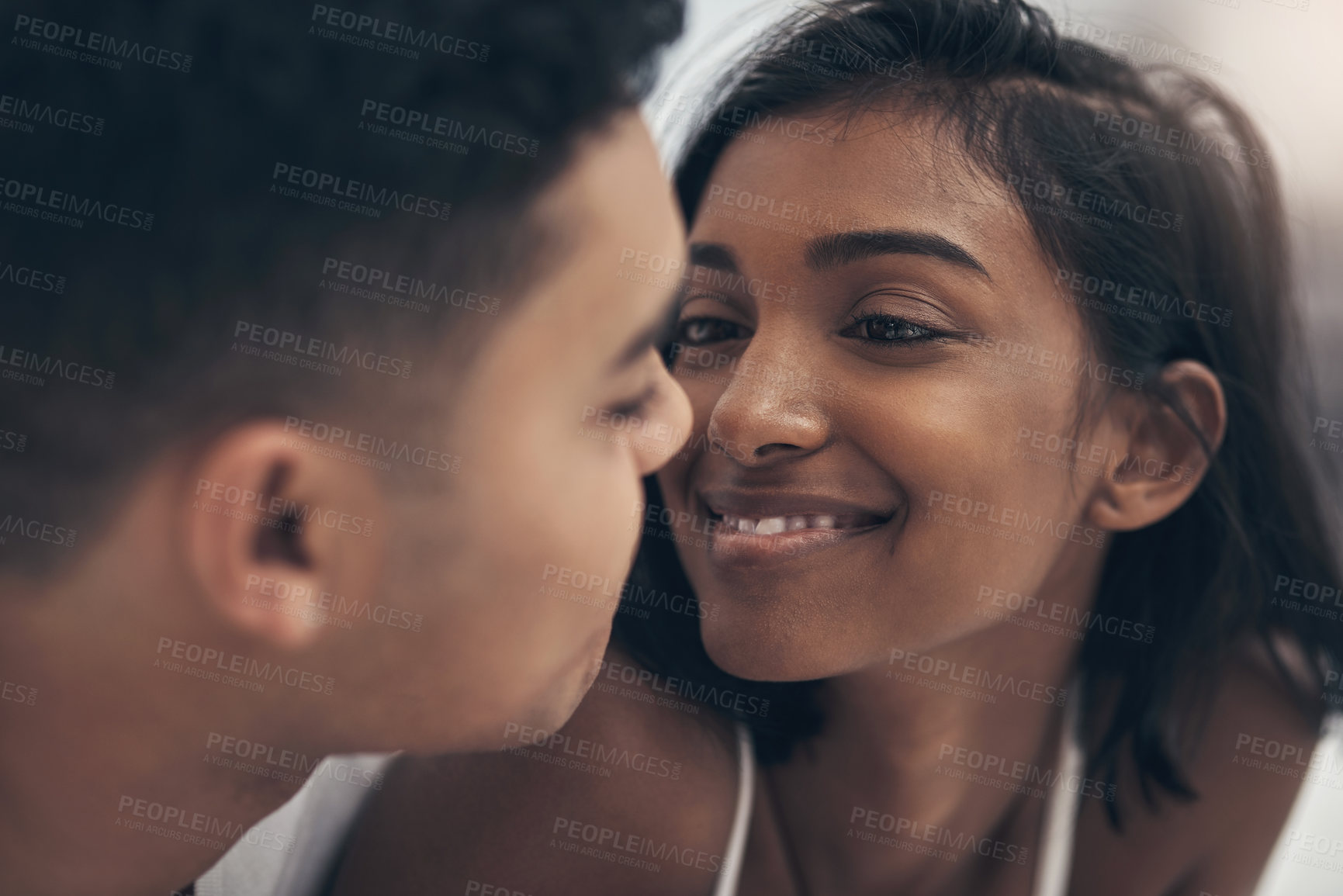 Buy stock photo Shot of a young couple sharing an intimate moment at home