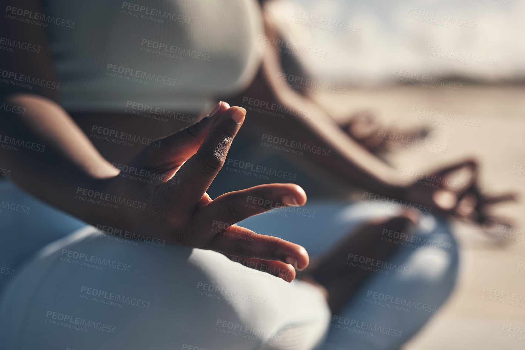 Buy stock photo Shot of a woman meditating during her yoga routine on the beach