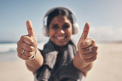 Buy stock photo Shot of a woman showing thumbs up while out for a workout