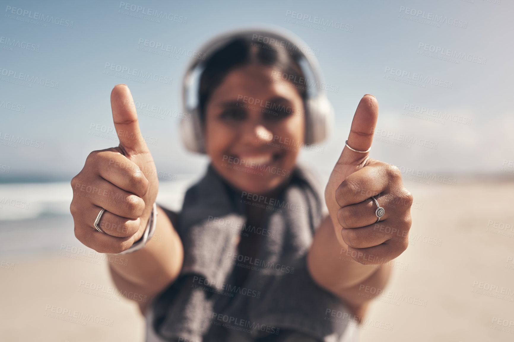 Buy stock photo Shot of a woman showing thumbs up while out for a workout