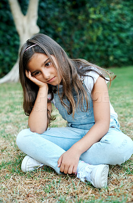 Buy stock photo Girl child, lonely and sad or bored in nature, disappointed or sitting on grass in backyard lawn alone. Kid, upset and unhappy with melancholy, depressed face or solitude for summer in garden or park