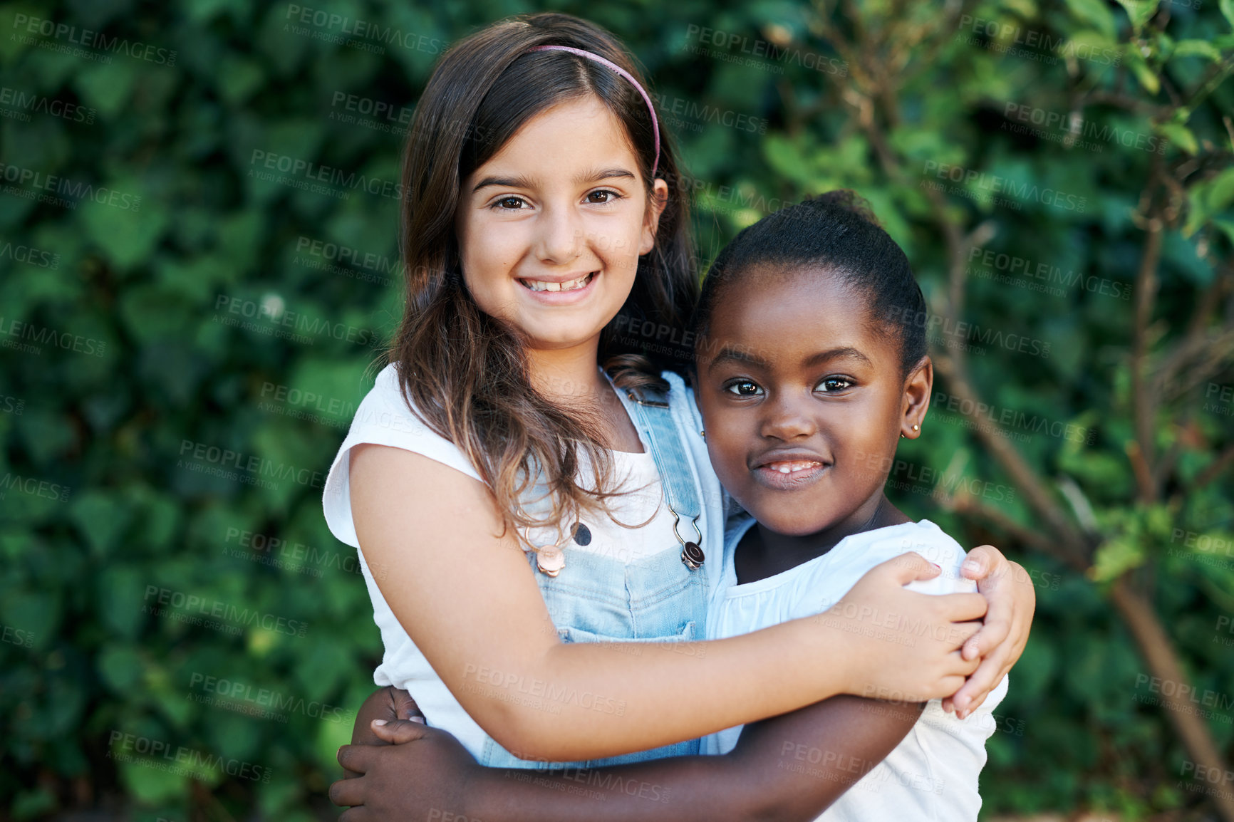 Buy stock photo Children, diversity and hug with girl friends outdoor in garden together for summer bonding. Love, portrait and smile with young kids embracing in nature or park for development, growth or support