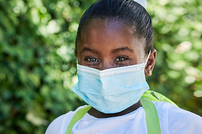 Buy stock photo Shot of a little girl wearing a mask outside