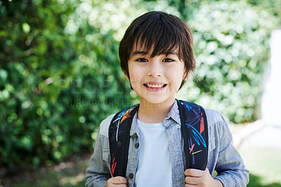 Buy stock photo Shot of a little boy wearing a backpack in nature