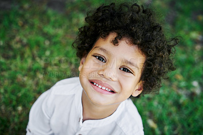 Buy stock photo Shot of a little boy smiling in nature