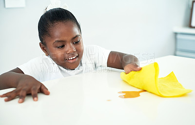 Buy stock photo African kid, cloth and cleaning table in home kitchen for hygiene, chores or housekeeping maintenance. Happy girl, child and wipe counter with coffee spill for learning housework, help or development