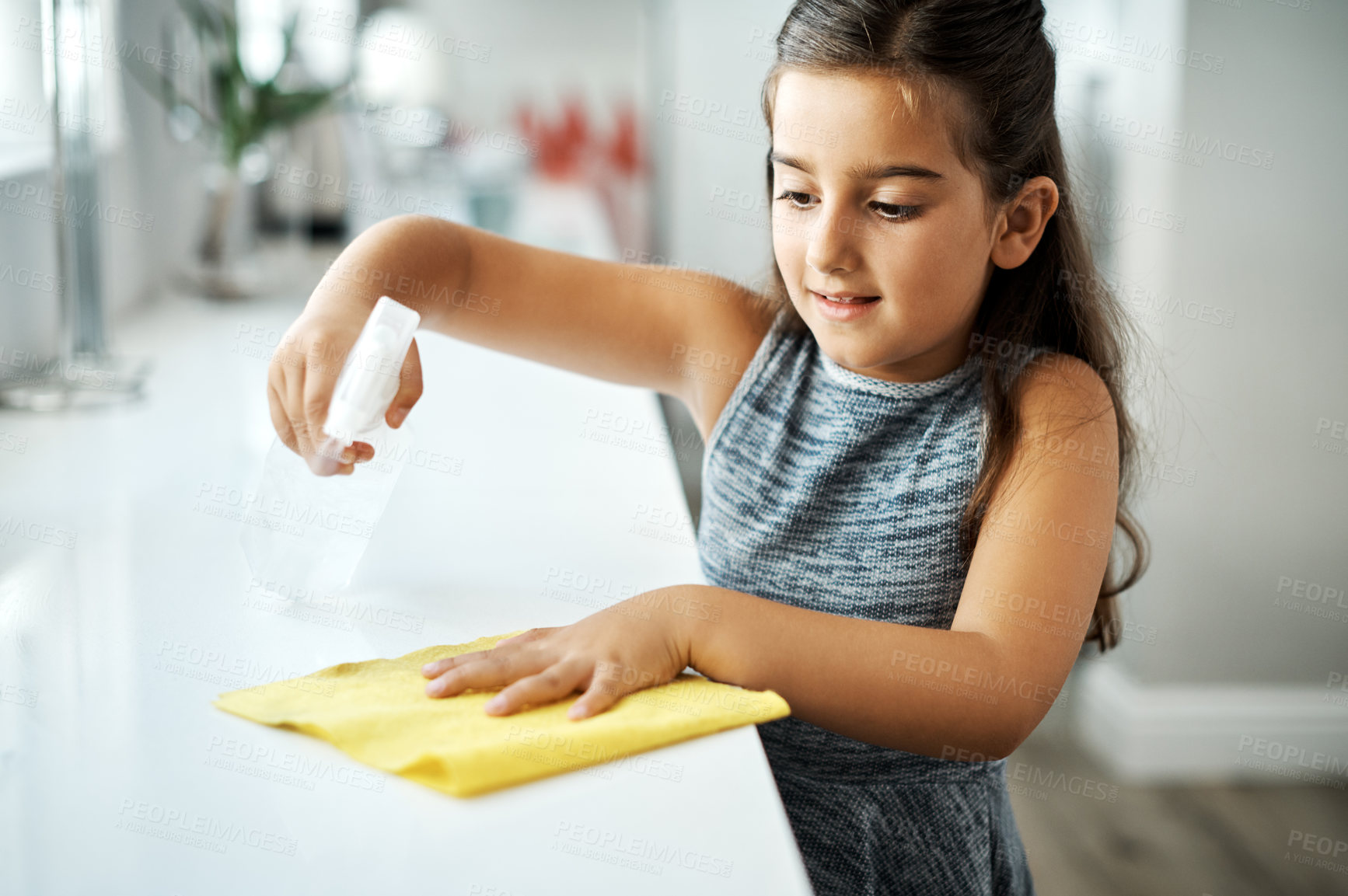 Buy stock photo Cloth, spray and child cleaning table in home for hygiene, chores or housekeeping maintenance. Girl, kid or wipe kitchen counter to disinfect for learning housework, education or help for development