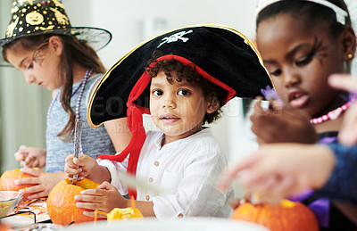 Buy stock photo Shot of a group of little children cleaning pumpkins at a party