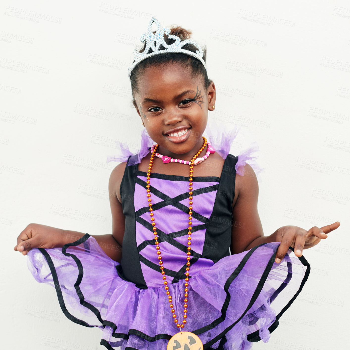 Buy stock photo Halloween, portrait and African child with costume for fantasy event, birthday party and crown in studio. Black girl, youth and tiara for creative fashion and princess clothes by white background