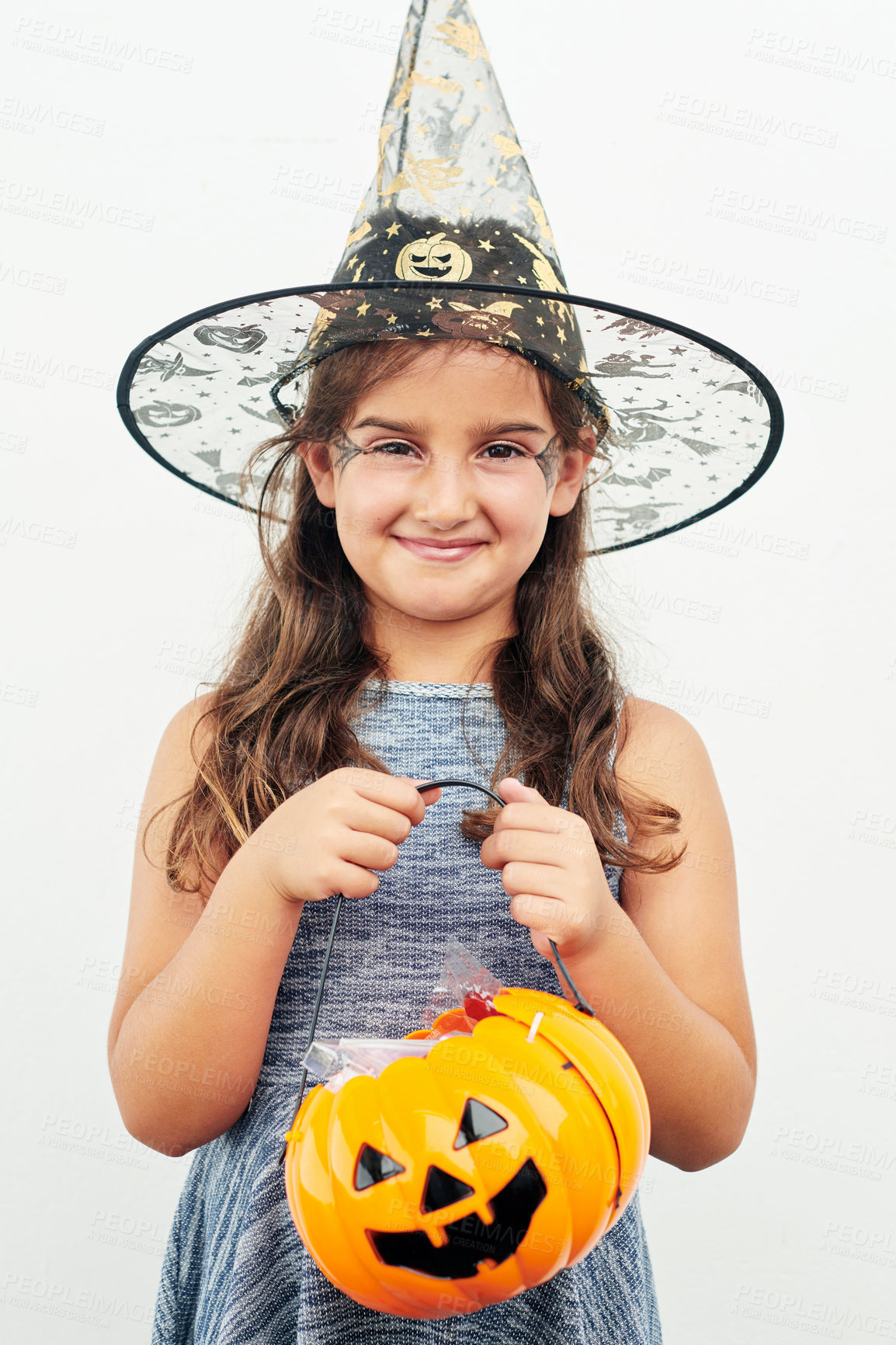 Buy stock photo Portrait, girl and witch costume for halloween, birthday or party at event as child to celebrate. Youth, creative and candy bucket for trick or treat, fantasy or holiday tradition in America for play