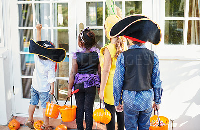 Buy stock photo Shot of a group of unrecognizable little children going trick-or-treating