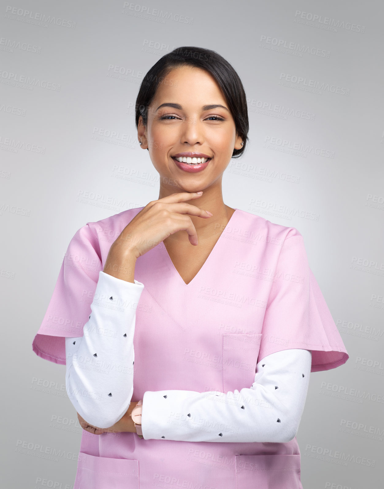 Buy stock photo Cropped portrait of an attractive young female healthcare worker standing in studio against a grey background