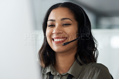 Buy stock photo Shot of a young businesswoman wearing a headset while working in a call centre