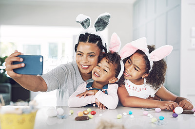 Buy stock photo Shot of a mother taking a selfie with her daughters at home