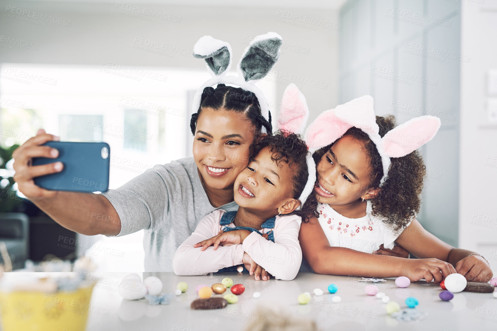Buy stock photo Shot of a mother taking a selfie with her daughters at home