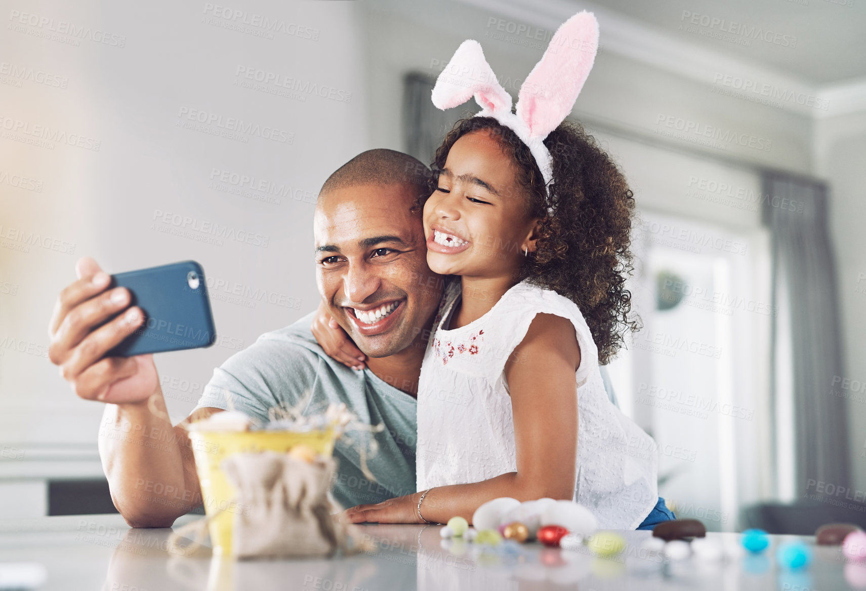 Buy stock photo Shot of a father and daughter taking a selfie at home